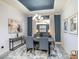 Formal dining room with elegant chandelier, artwork, and a view of the outdoor landscape at 10450 Highland Park Pl, Palmetto, FL 34221