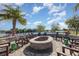 Cozy community fire pit area surrounded by comfortable chairs, perfect for outdoor gatherings and enjoying serene lake views at 10450 Highland Park Pl, Palmetto, FL 34221