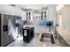 Contemporary kitchen with stainless steel appliances, granite counters, and a convenient kitchen island at 10450 Highland Park Pl, Palmetto, FL 34221