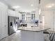 Modern kitchen with stainless steel appliances, granite countertops, and ample cabinet space at 10450 Highland Park Pl, Palmetto, FL 34221