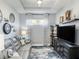 Comfortable living room with stylish decor, including a grey couch and modern entertainment center at 10450 Highland Park Pl, Palmetto, FL 34221