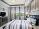 Inviting main bedroom featuring a plush bed, a modern ceiling, and an array of windows for lots of natural light at 10450 Highland Park Pl, Palmetto, FL 34221