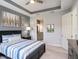 Stylish main bedroom showcases a modern ceiling, coordinated decor, and convenient access to an adjacent bathroom at 10450 Highland Park Pl, Palmetto, FL 34221