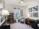 Bright home office featuring a work desk, chair, and display cabinet with natural light from the window at 10450 Highland Park Pl, Palmetto, FL 34221