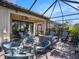 Relaxing outdoor space featuring a cozy seating area, ceiling fan, and a screened-in patio for bug-free enjoyment at 10450 Highland Park Pl, Palmetto, FL 34221