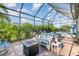 Relaxing patio with a hot tub, fire table, comfortable seating, and a private, enclosed space at 10450 Highland Park Pl, Palmetto, FL 34221