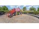 Safe and fun community playground with colorful play equipment and a secure, mulched play area at 10450 Highland Park Pl, Palmetto, FL 34221