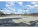 Well-maintained tennis courts surrounded by lush greenery and palm trees under a bright sky, ideal for recreation at 10450 Highland Park Pl, Palmetto, FL 34221