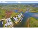 Aerial view of waterfront property highlighting its scenic location and community layout near the water at 1134 Starfish Ln, Tarpon Springs, FL 34689
