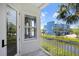 Balcony view overlooking a canal, showcasing the building's blue exterior and lush landscaping at 1134 Starfish Ln, Tarpon Springs, FL 34689
