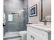 Modern bathroom featuring a glass-enclosed shower, sleek white vanity, and contemporary finishes at 1134 Starfish Ln, Tarpon Springs, FL 34689