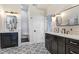 Bathroom showcasing patterned tile floors, dual vanities, and a walk-in shower, creating a luxurious experience at 1134 Starfish Ln, Tarpon Springs, FL 34689