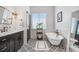 Elegant bathroom featuring a clawfoot tub, decorative tile flooring, and stylish fixtures at 1134 Starfish Ln, Tarpon Springs, FL 34689