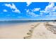 Picturesque view of the beach with views of the water and blue skies at 1134 Starfish Ln, Tarpon Springs, FL 34689