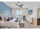 Bright bedroom featuring a large window, ceiling fan, and a cozy bed with blue accents at 1134 Starfish Ln, Tarpon Springs, FL 34689