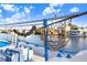 Close-up showcasing the boat's details, including sponge fishing net, and blue trim against a backdrop of the marina at 1134 Starfish Ln, Tarpon Springs, FL 34689