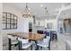 Bright dining room boasts a modern chandelier, a large mirror, and an open layout to the kitchen area at 1134 Starfish Ln, Tarpon Springs, FL 34689