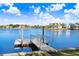 Community dock overlooking calm waters with waterfront homes in the distance at 1134 Starfish Ln, Tarpon Springs, FL 34689