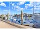 Scenic view of a docked boat with blue and white trim, surrounded by a tranquil marina setting under a partly cloudy sky at 1134 Starfish Ln, Tarpon Springs, FL 34689