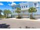 Beautiful three-story condo with an attached garage and a balcony that overlooks the waterfront and palm trees at 1134 Starfish Ln, Tarpon Springs, FL 34689