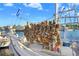 Fishing boat adorned with sponges and flags, docked in a marina with other boats, offering a unique nautical view at 1134 Starfish Ln, Tarpon Springs, FL 34689
