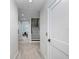 Hallway featuring a staircase and open doorway, providing an airy, spacious feel at 1134 Starfish Ln, Tarpon Springs, FL 34689