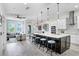 Open kitchen layout with large island, modern appliances, and an adjacent living area at 1134 Starfish Ln, Tarpon Springs, FL 34689