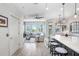 Bright, open-concept kitchen featuring a large island with counter seating, stainless appliances, and modern finishes at 1134 Starfish Ln, Tarpon Springs, FL 34689