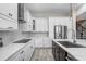 Bright kitchen featuring modern appliances, white cabinets, and a stylish backsplash at 1134 Starfish Ln, Tarpon Springs, FL 34689