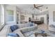Open-concept living room flowing into a modern kitchen with stainless steel appliances and a large island at 1134 Starfish Ln, Tarpon Springs, FL 34689