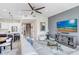 Open-concept living space with modern furnishings, a ceiling fan, and kitchen access at 1134 Starfish Ln, Tarpon Springs, FL 34689