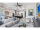 Open-concept living room flowing into a modern kitchen with stainless steel appliances and a large island at 1134 Starfish Ln, Tarpon Springs, FL 34689