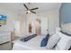Serene main bedroom features a king-size bed, ceiling fan, and an en-suite bathroom and walk-in closet at 1134 Starfish Ln, Tarpon Springs, FL 34689