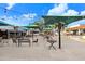 Outdoor dining with many chairs and tables, and large umbrellas. Perfect for outdoor meals at 1134 Starfish Ln, Tarpon Springs, FL 34689