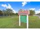 The park sign displays amenities such as fitness area, dog park, and canoe/kayak launch at 1134 Starfish Ln, Tarpon Springs, FL 34689