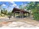 Large picnic pavilion featuring green picnic tables and charcoal grills at 1134 Starfish Ln, Tarpon Springs, FL 34689
