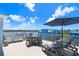 Stylish rooftop deck with an outdoor kitchen, grill, and comfortable seating, ideal for enjoying scenic views at 1134 Starfish Ln, Tarpon Springs, FL 34689