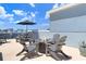 Inviting rooftop deck featuring a fire pit surrounded by Adirondack chairs for cozy outdoor gatherings at 1134 Starfish Ln, Tarpon Springs, FL 34689