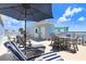 Expansive rooftop deck with an outdoor kitchen, dining area, and lounge chairs for ultimate relaxation at 1134 Starfish Ln, Tarpon Springs, FL 34689