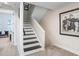 Carpeted staircase with white walls and a picture, offering a seamless transition between floors at 1134 Starfish Ln, Tarpon Springs, FL 34689