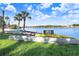 Beautiful waterfront view with canoes, palm trees and blue skies at 1134 Starfish Ln, Tarpon Springs, FL 34689
