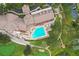 Aerial view of the pool, golf course, and clubhouse amenities, offering resort-style living at 11752 Wayside Willow Ct, Hudson, FL 34667