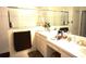Well-lit bathroom featuring a double vanity and walk-in shower at 11752 Wayside Willow Ct, Hudson, FL 34667