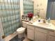Well-maintained bathroom with a vanity, toilet, and shower at 11752 Wayside Willow Ct, Hudson, FL 34667