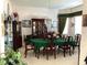 Formal dining room with wood furniture, china cabinet, and floral centerpiece at 11752 Wayside Willow Ct, Hudson, FL 34667