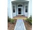Inviting entryway featuring a decorative walkway and sheltered porch at 11752 Wayside Willow Ct, Hudson, FL 34667
