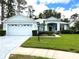 Charming single-story home featuring a well-maintained lawn, two-car garage, and a lovely covered entryway at 11752 Wayside Willow Ct, Hudson, FL 34667