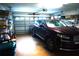 Spacious garage featuring a dark SUV and ample storage shelving on both sides for organized storage at 11752 Wayside Willow Ct, Hudson, FL 34667
