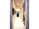 Bright hallway featuring arched doorways and neutral paint at 11752 Wayside Willow Ct, Hudson, FL 34667