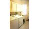 Functional laundry room with washer, dryer, and storage cabinets at 11752 Wayside Willow Ct, Hudson, FL 34667